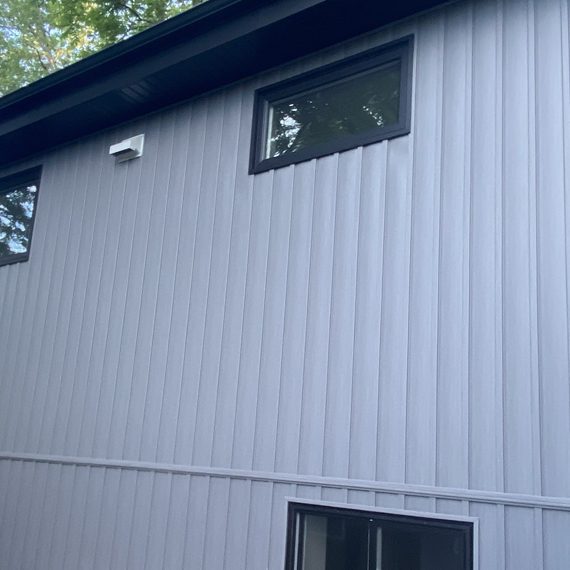 Close of of grey vertical board and batten siding installation