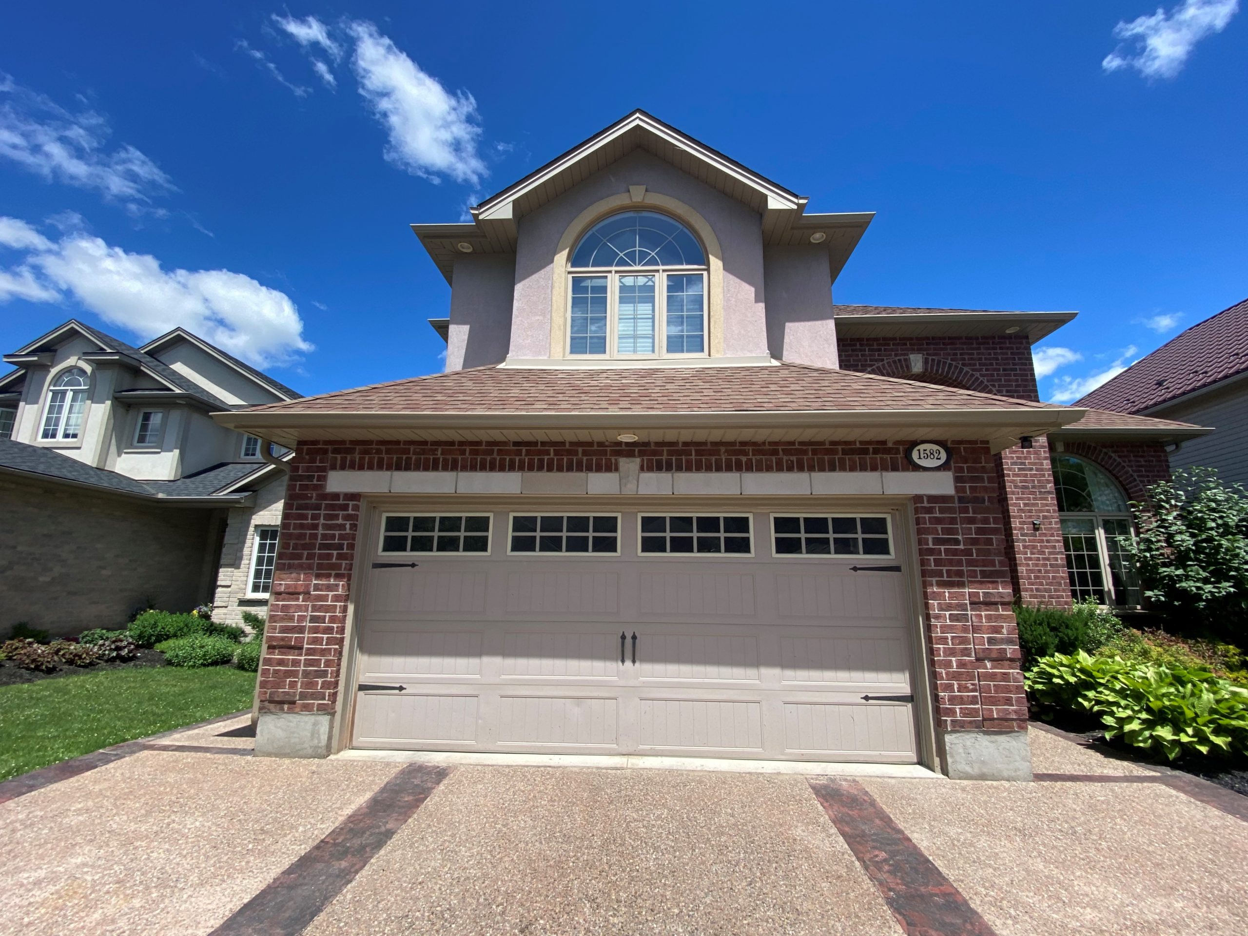 home with multiple stories and peaks that needs more labour for installing new gutters