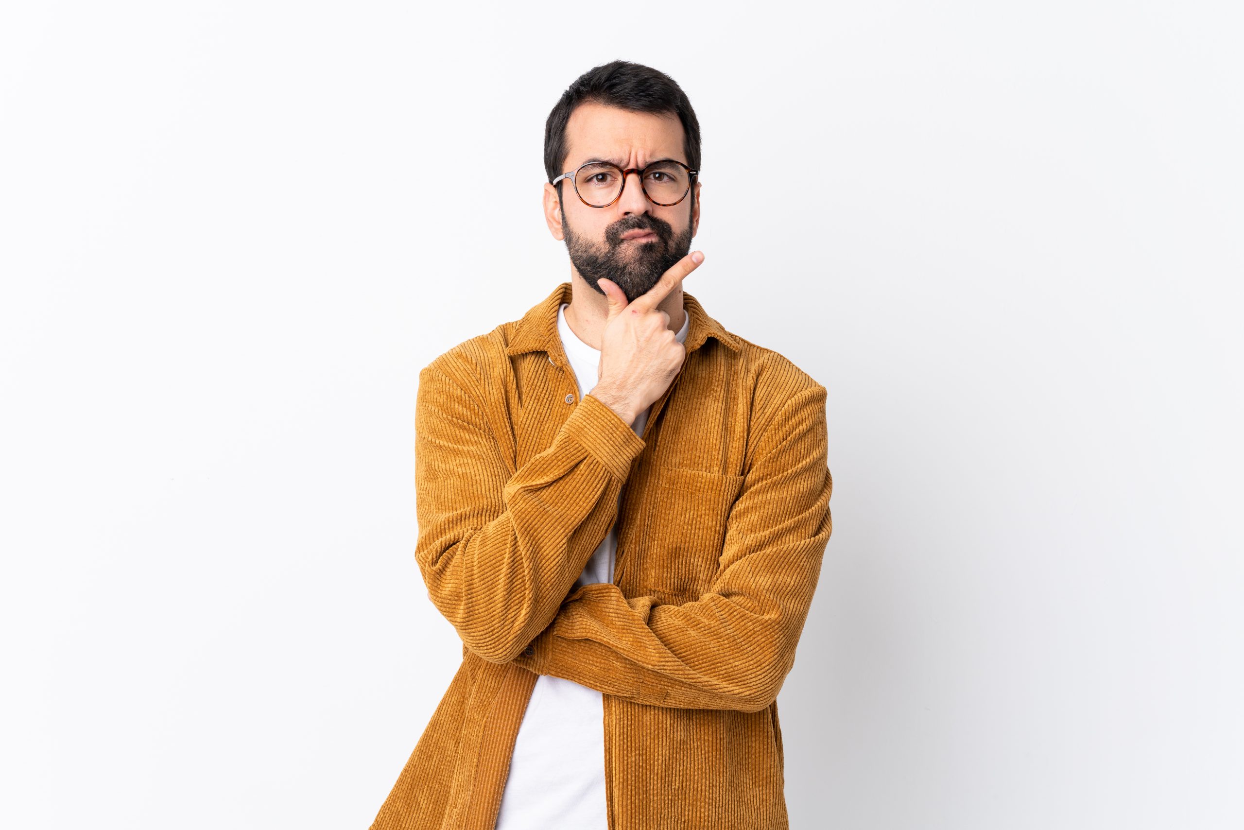 man with beard wearing a corduroy jacket thinking